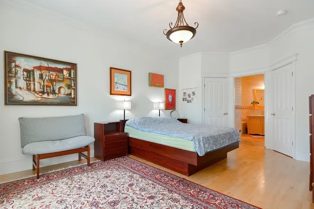 a bedroom with a bed and a chandelier