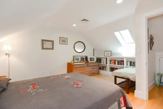 a bedroom with a bed and chandelier
