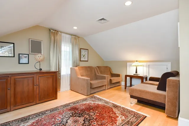a bedroom with furniture and a wooden floor