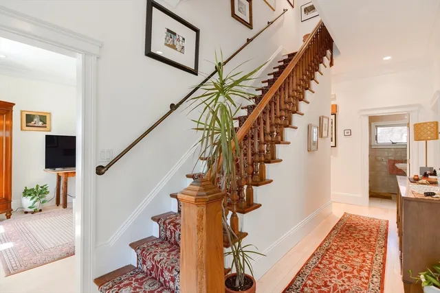 a view of entryway and hall with wooden floor