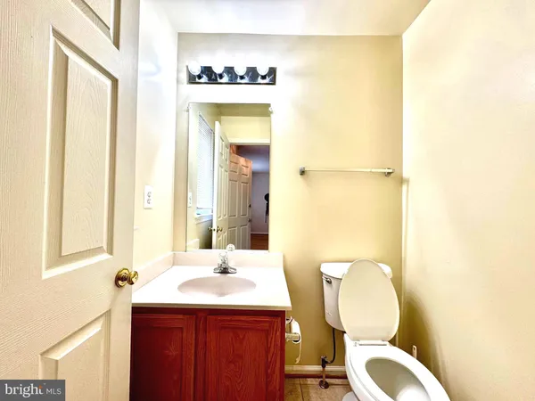 a bathroom with a granite countertop sink mirror and a toilet