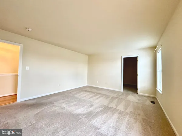 a view of an empty room and a window