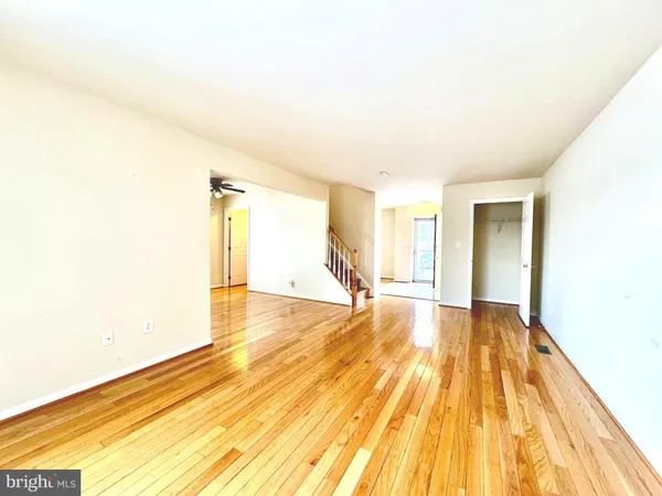 a view of empty room with wooden floor