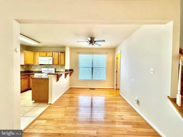a view of a kitchen with wooden floor and a kitchen