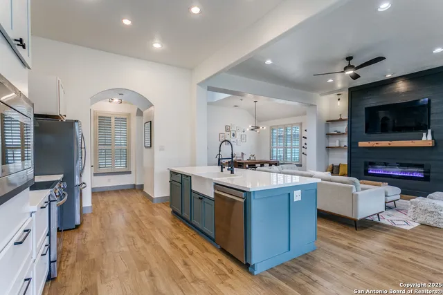 a kitchen with stainless steel appliances granite countertop a stove oven and a refrigerator