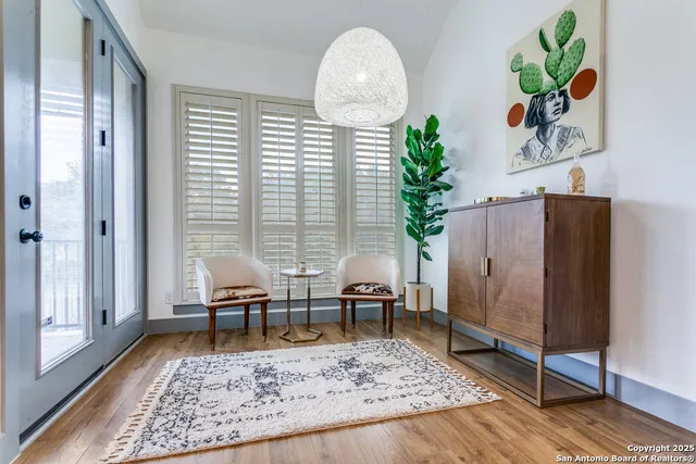 a living room with furniture and a potted plant