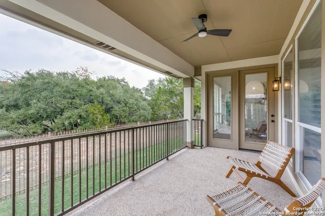 a balcony with furniture and a chandelier