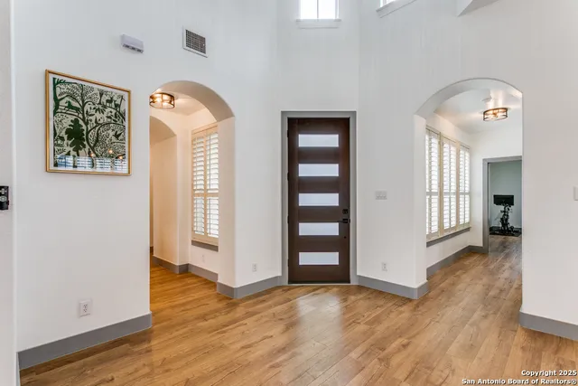 a view of a hallway with wooden floor