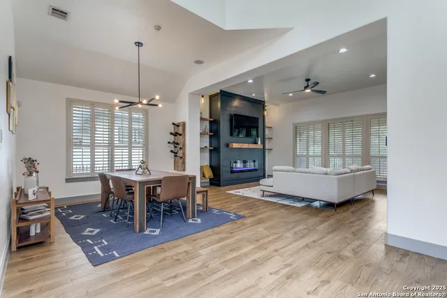 a living room with furniture a wooden floor and a chandelier