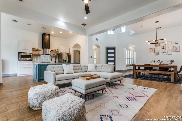 a living room with furniture and view of kitchen