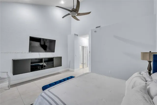 a living room with dining table furniture a window and a chandelier