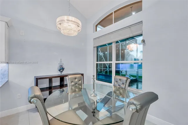 a kitchen with stainless steel appliances granite countertop a sink a stove a microwave a refrigerator and cabinets