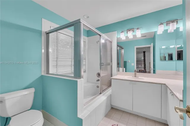 a view of a house with a yard and potted plants