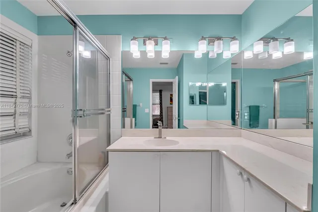 a view of a big house with a big yard and potted plants in front of it