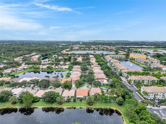 a view of a house with a yard and potted plants