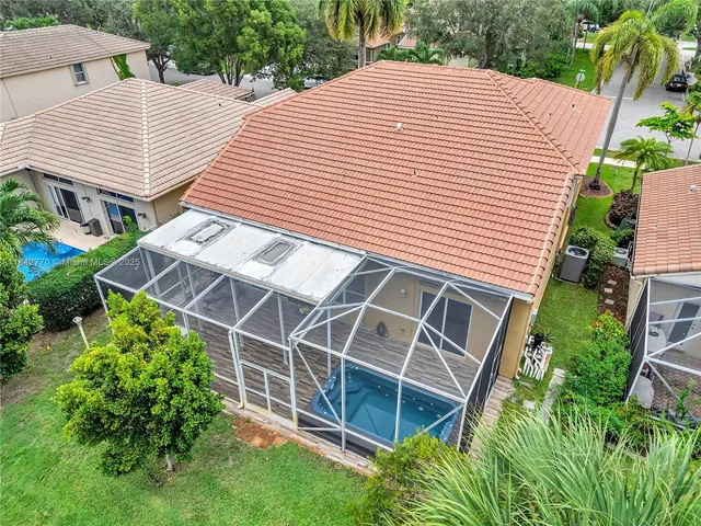 an aerial view of house with yard swimming pool and outdoor seating