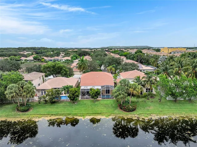 an aerial view of a house with a lake view