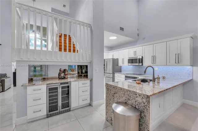 a kitchen with cabinets and window