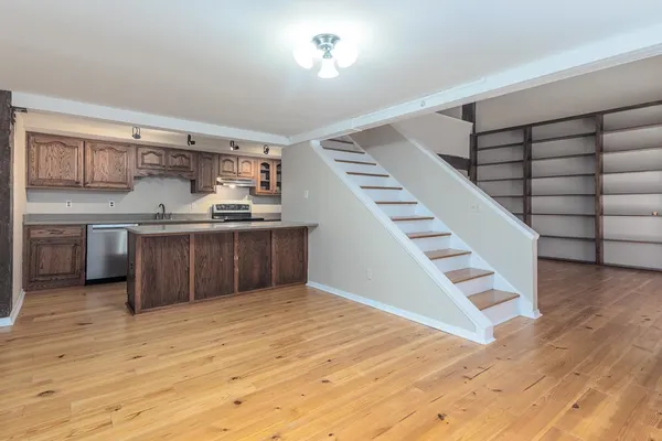 a kitchen with stainless steel appliances granite countertop a stove and cabinets