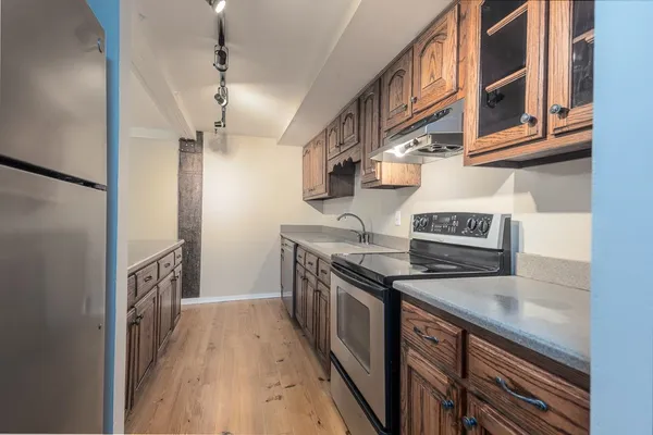 a kitchen with stainless steel appliances granite countertop a stove and a sink