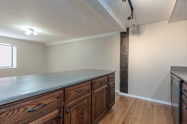 a view of a storage and utility room with wooden floor