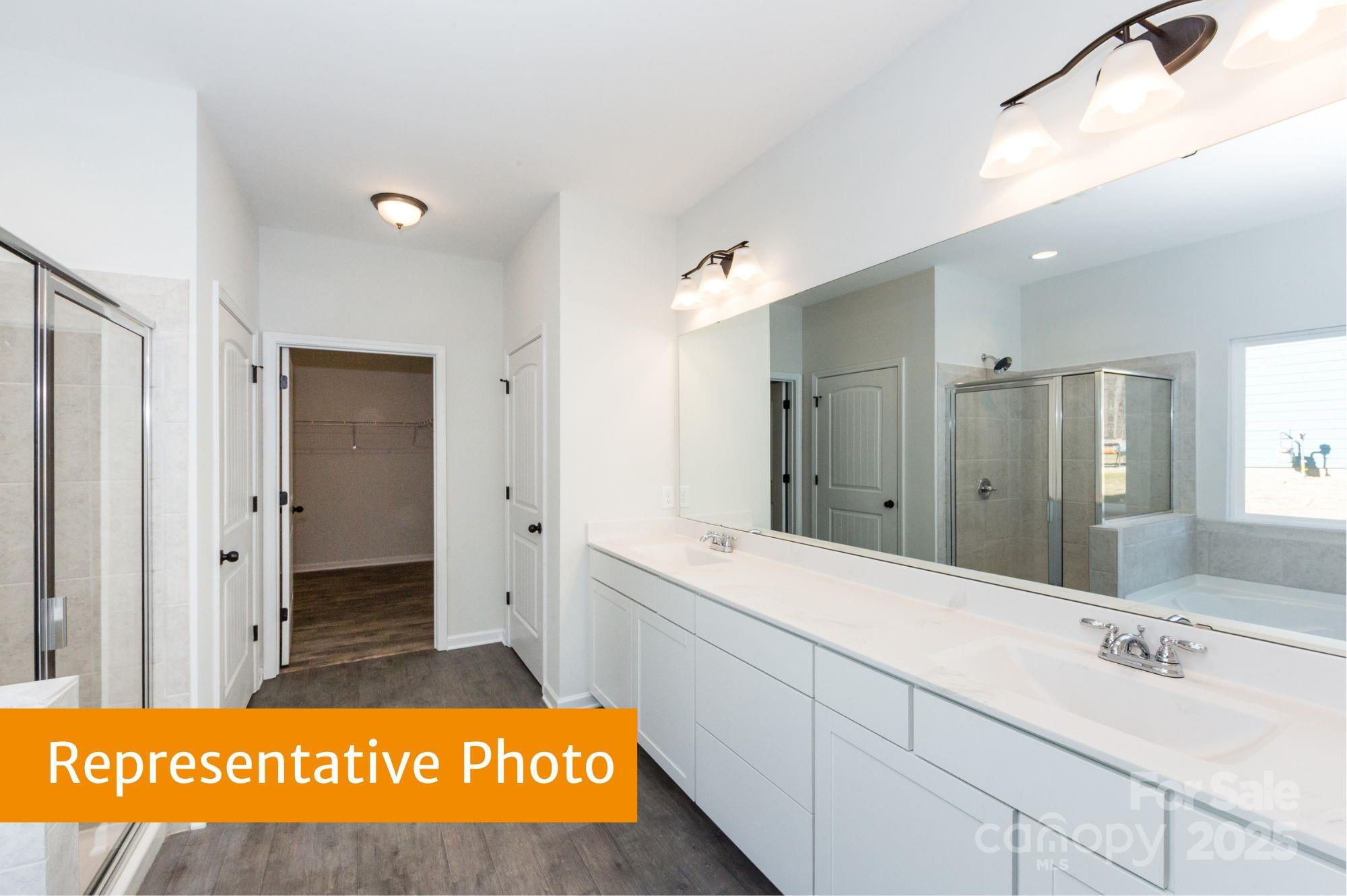 12155 Muscadine Court Midland, NC 28107 - Photo 13 of 20 a bathroom with a sink a mirror and a shower
