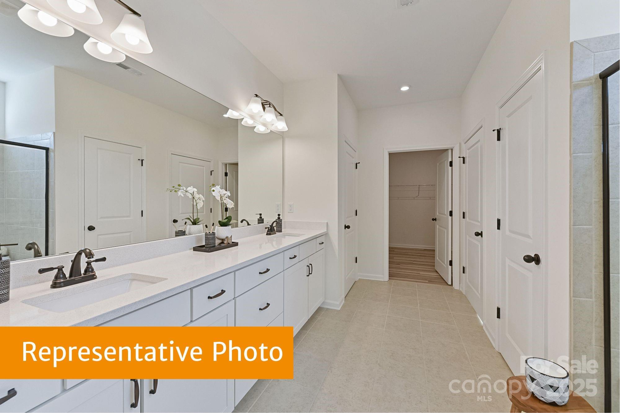 12155 Muscadine Court Midland, NC 28107 - Photo 14 of 20 a bathroom with a sink a mirror and a shower