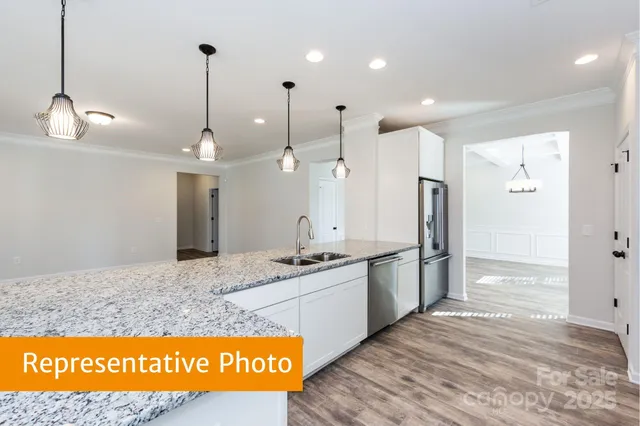 a view of a kitchen with a sink stove and refrigerator