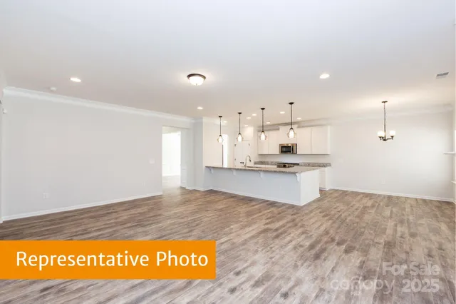 a view of kitchen with kitchen island sink and living room
