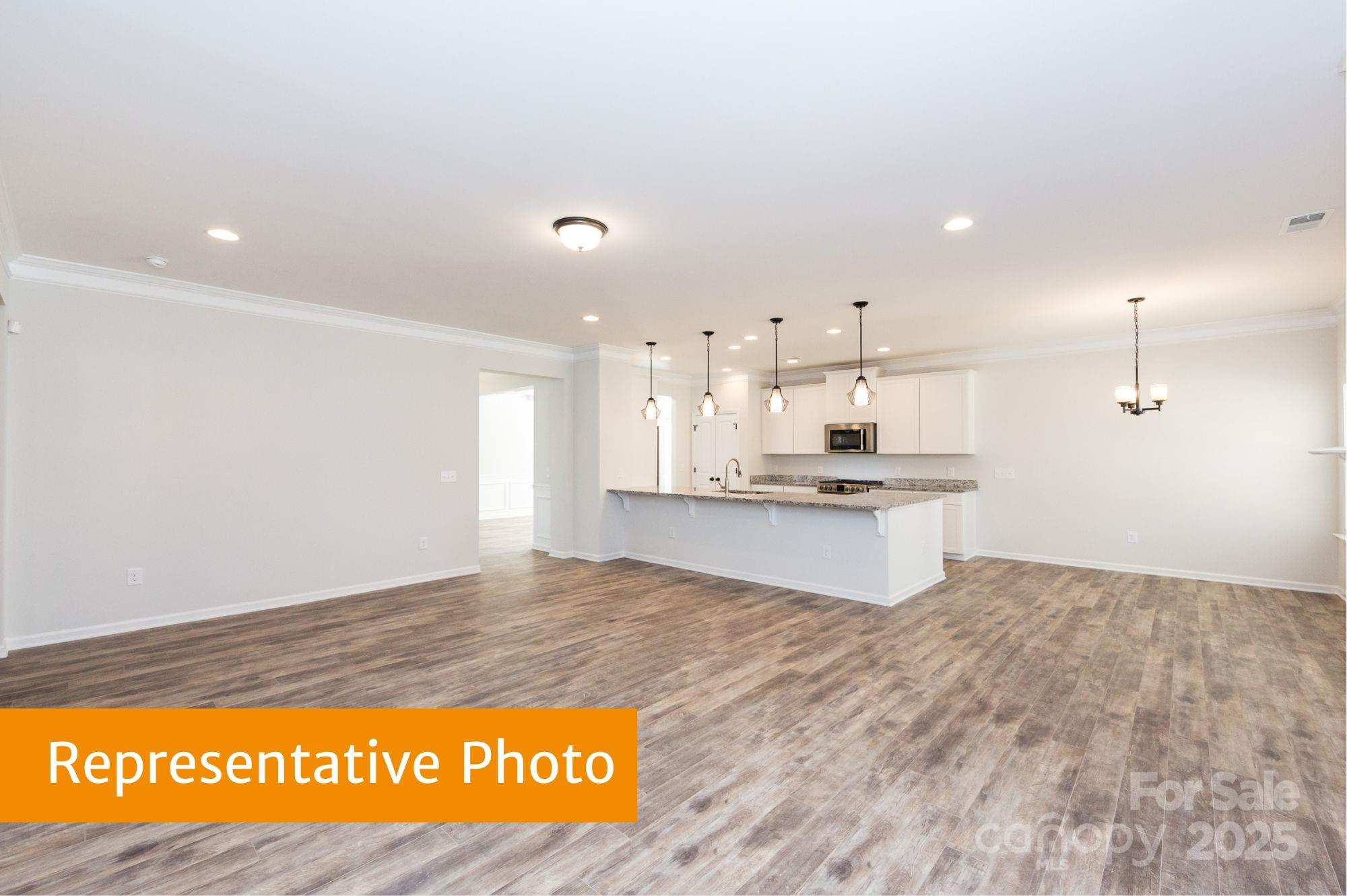 12155 Muscadine Court Midland, NC 28107 - Photo 6 of 20 a view of kitchen with kitchen island sink and living room