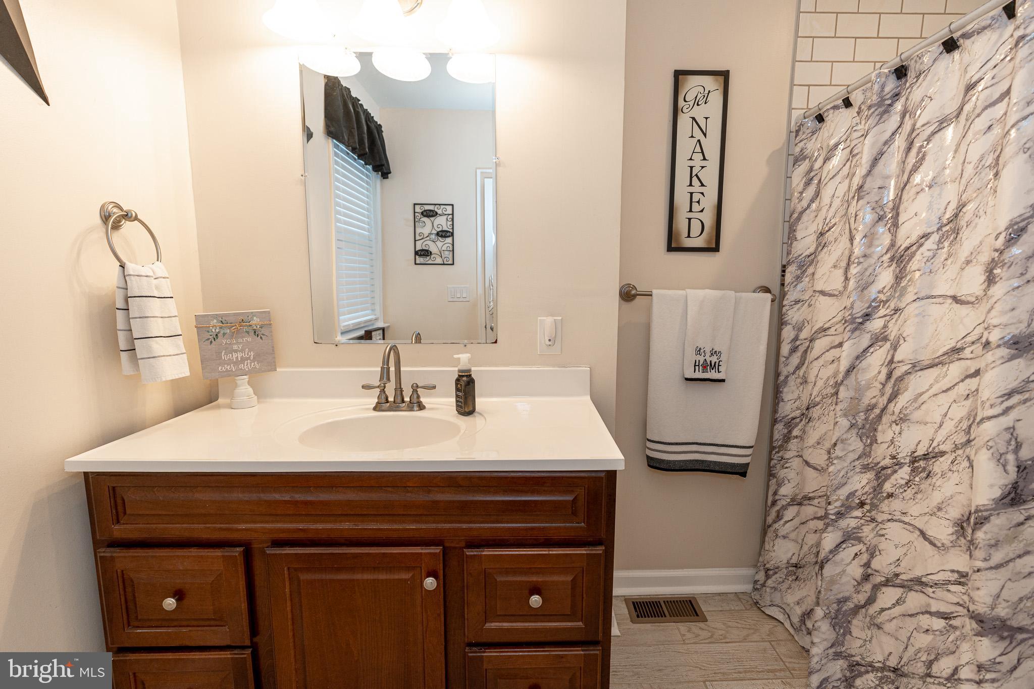 220 Pinewood Road Baltimore, MD 21222 - Photo 14 of 45 a bathroom with a sink and a mirror