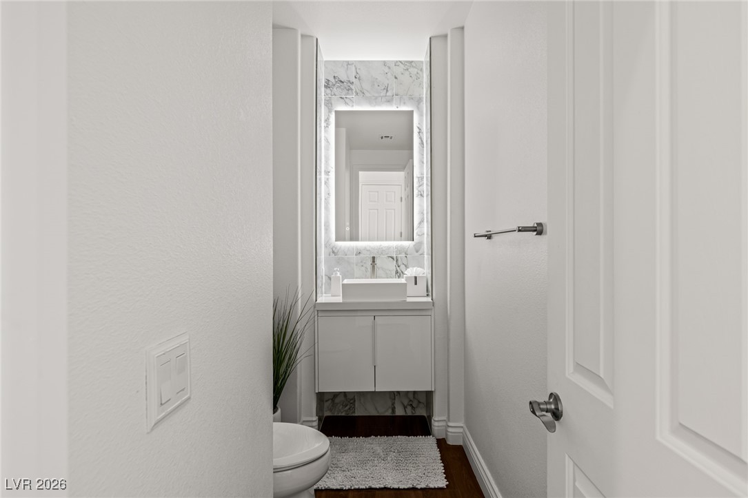 7304 North Buttons Ridge Drive Las Vegas, NV 89131 - Photo 36 of 92 The powder room mirrors that same luxury in a smaller scale.
