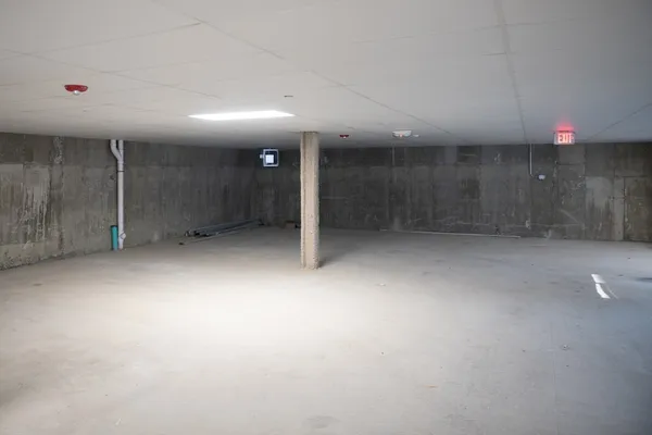 an empty room with an entryway and fan