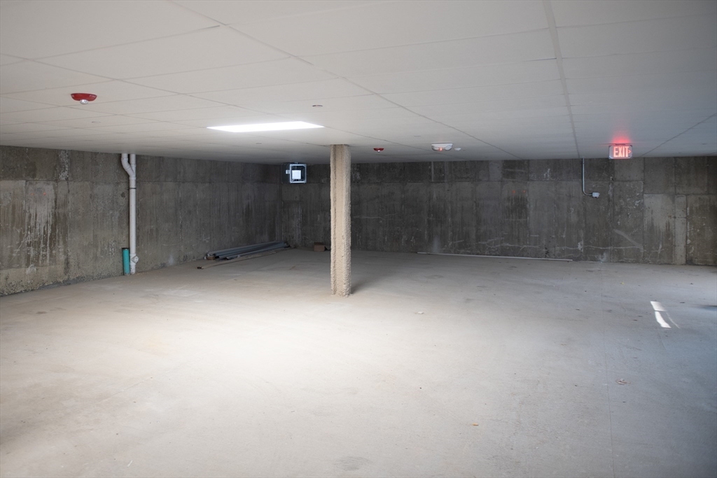 425 Border Street, Unit 307 Boston, MA 02128 - Photo 18 of 19 an empty room with an entryway and fan