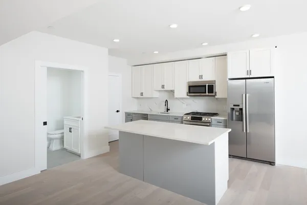 a kitchen with stainless steel appliances a refrigerator stove microwave and cabinets