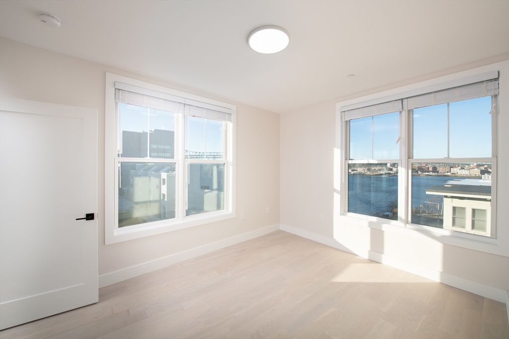 425 Border Street, Unit 307 Boston, MA 02128 - Photo 6 of 19 an empty room with windows