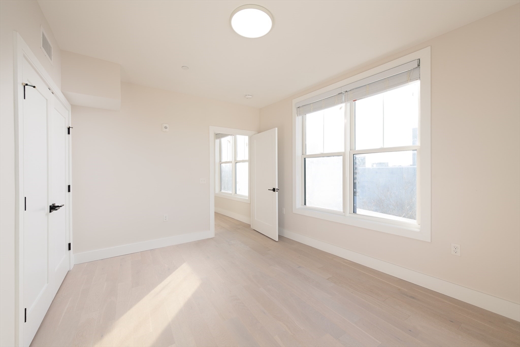 425 Border Street, Unit 307 Boston, MA 02128 - Photo 7 of 19 a view of an empty room with a window
