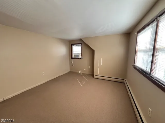 an empty room with windows and entrance