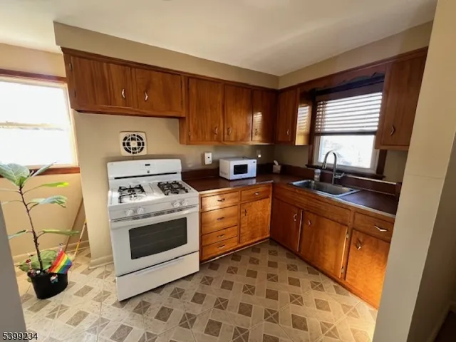 a kitchen with a stove sink and cabinets