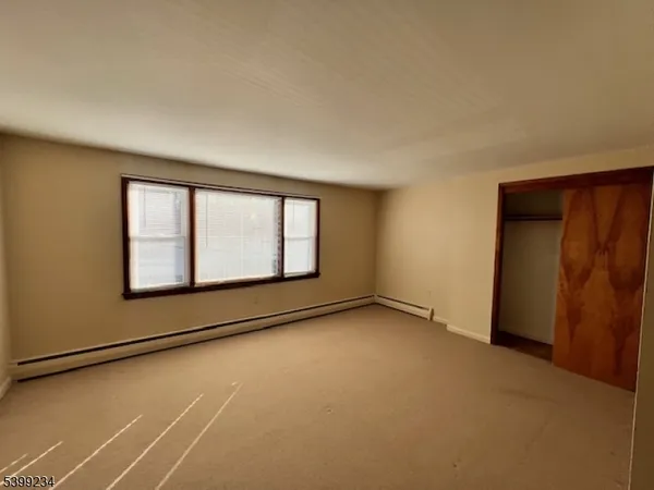 a view of an empty room with windows
