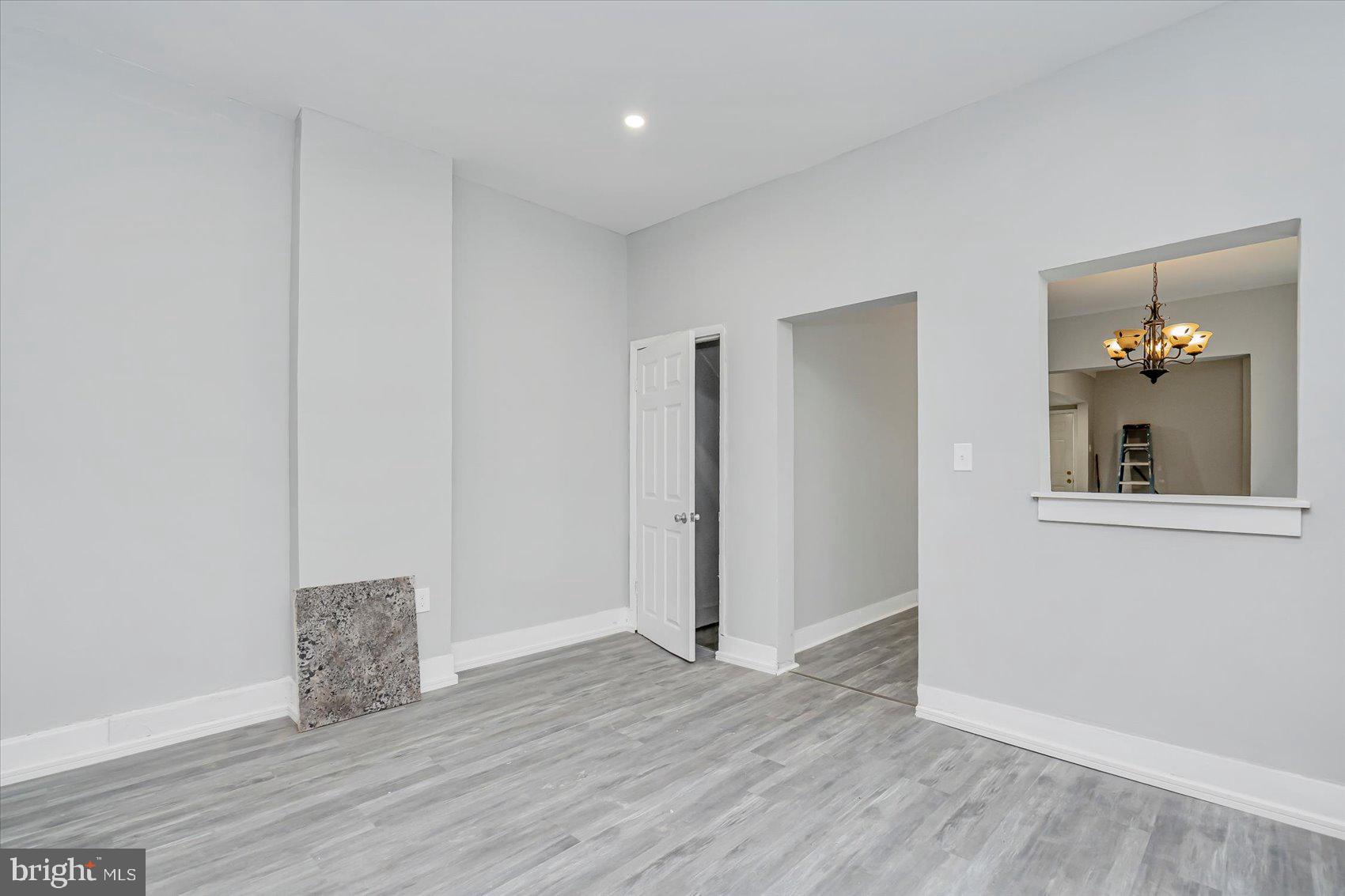 1607 Filbert Street Curtis Bay, MD 21226 - Photo 13 of 33 an empty room with wooden floor and windows