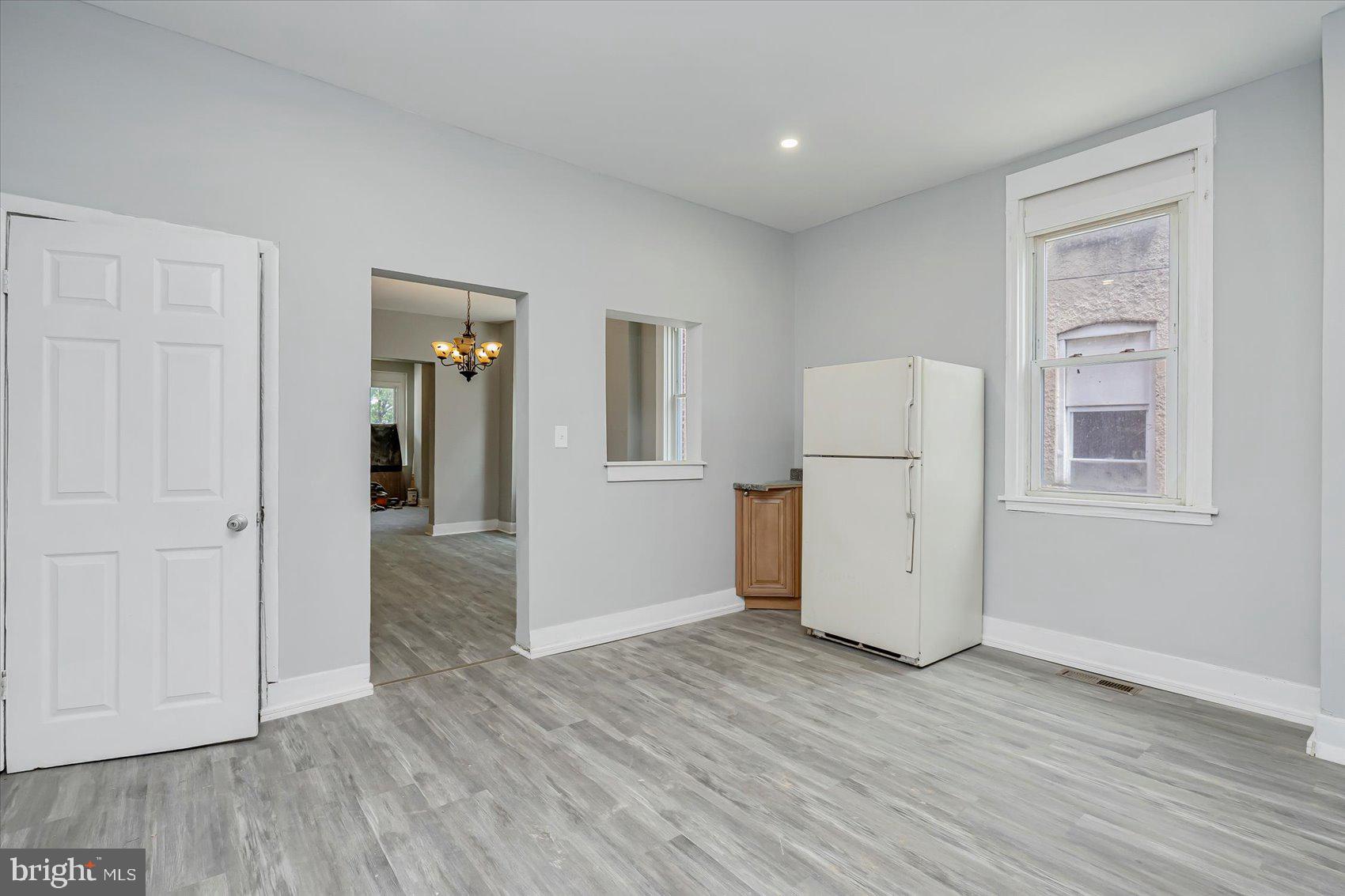 1607 Filbert Street Curtis Bay, MD 21226 - Photo 14 of 33 an empty room with wooden floor and cabinet