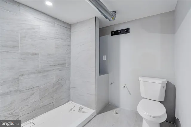 a white toilet sitting next to a bathroom sink