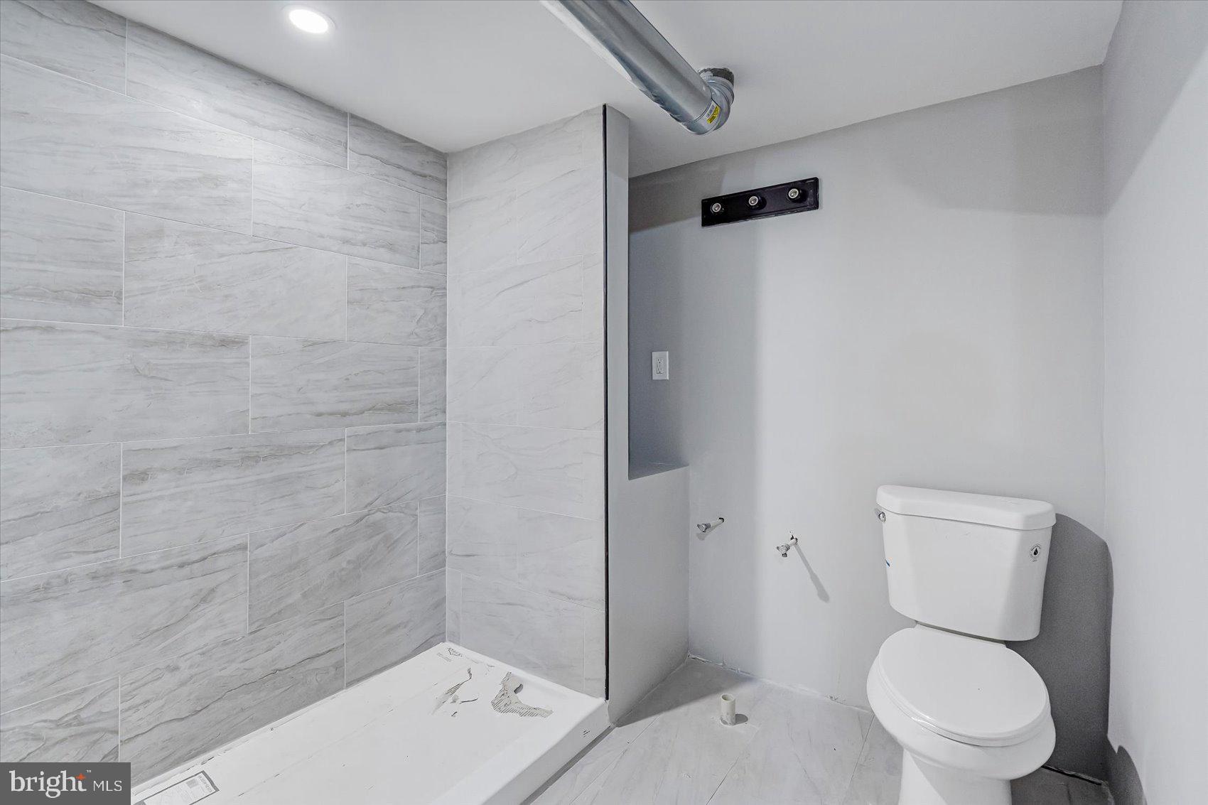 1607 Filbert Street Curtis Bay, MD 21226 - Photo 15 of 33 a white toilet sitting next to a bathroom sink