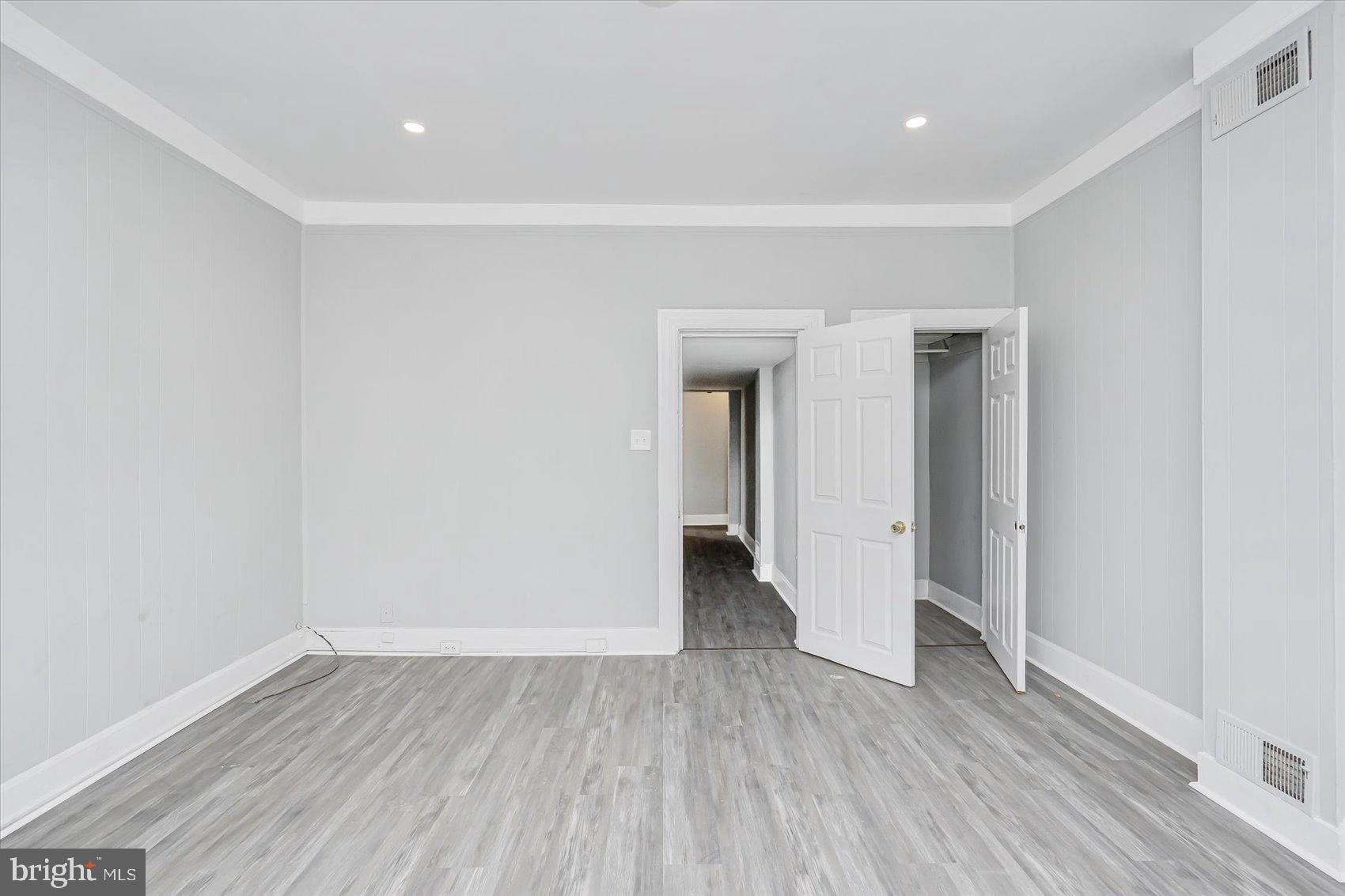 1607 Filbert Street Curtis Bay, MD 21226 - Photo 22 of 33 a view of an empty room with wooden floor and a window