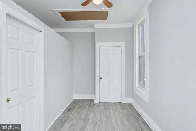 an empty room with wooden floor and closet
