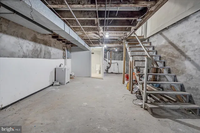 a view of an empty room with wooden ceiling