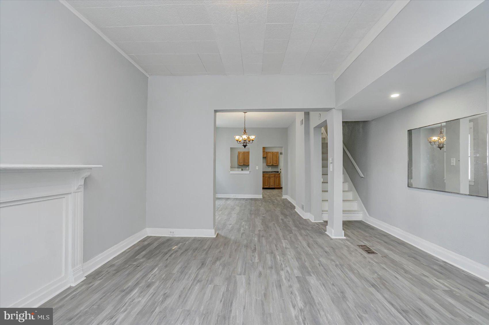 1607 Filbert Street Curtis Bay, MD 21226 - Photo 5 of 33 wooden floor in an empty room with a window