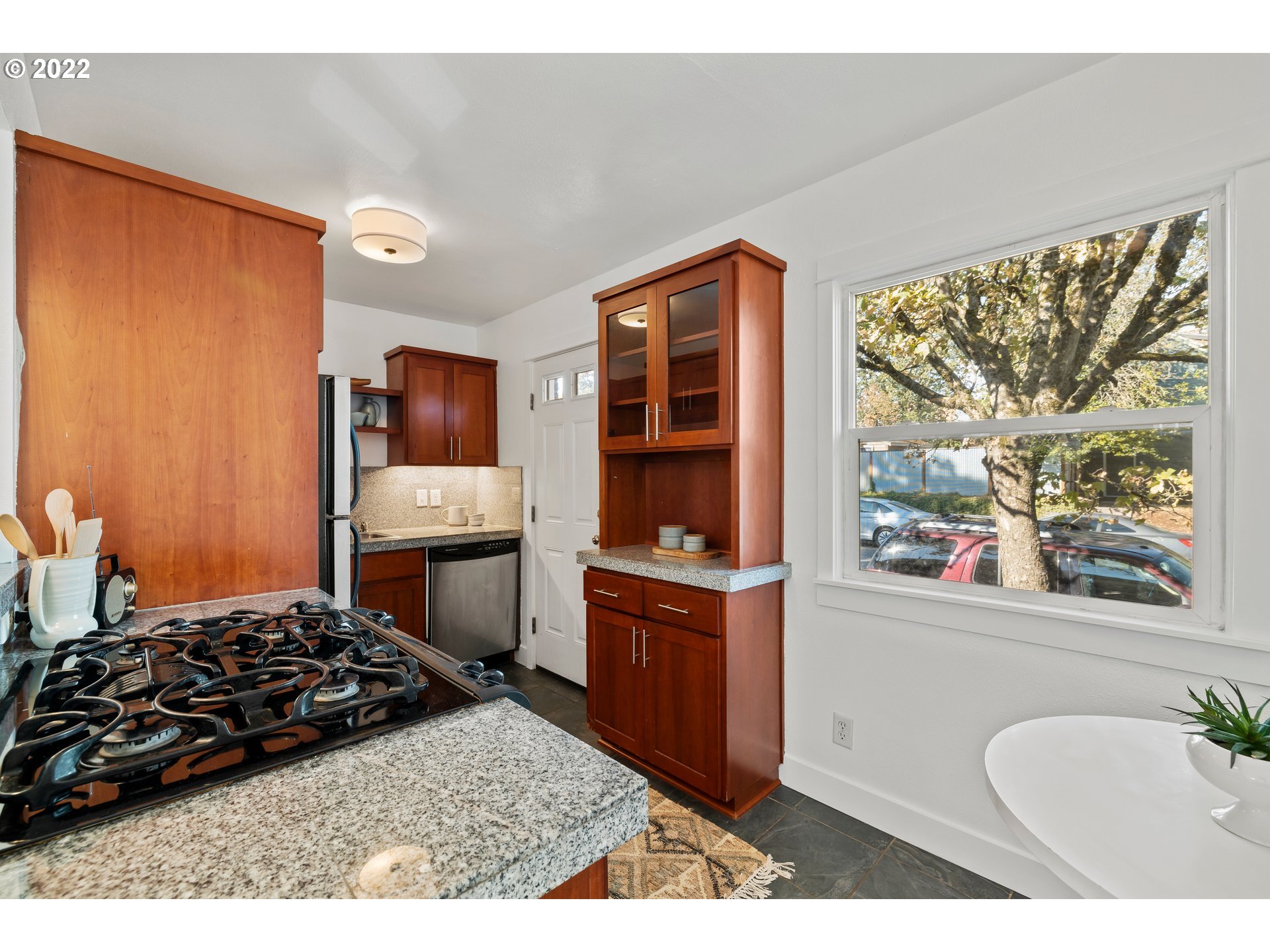 506 Northeast Rosa Parks Way, Unit 2 Portland, OR 97211 - Photo 5 of 17 a kitchen with stainless steel appliances granite countertop a stove a sink and a refrigerator