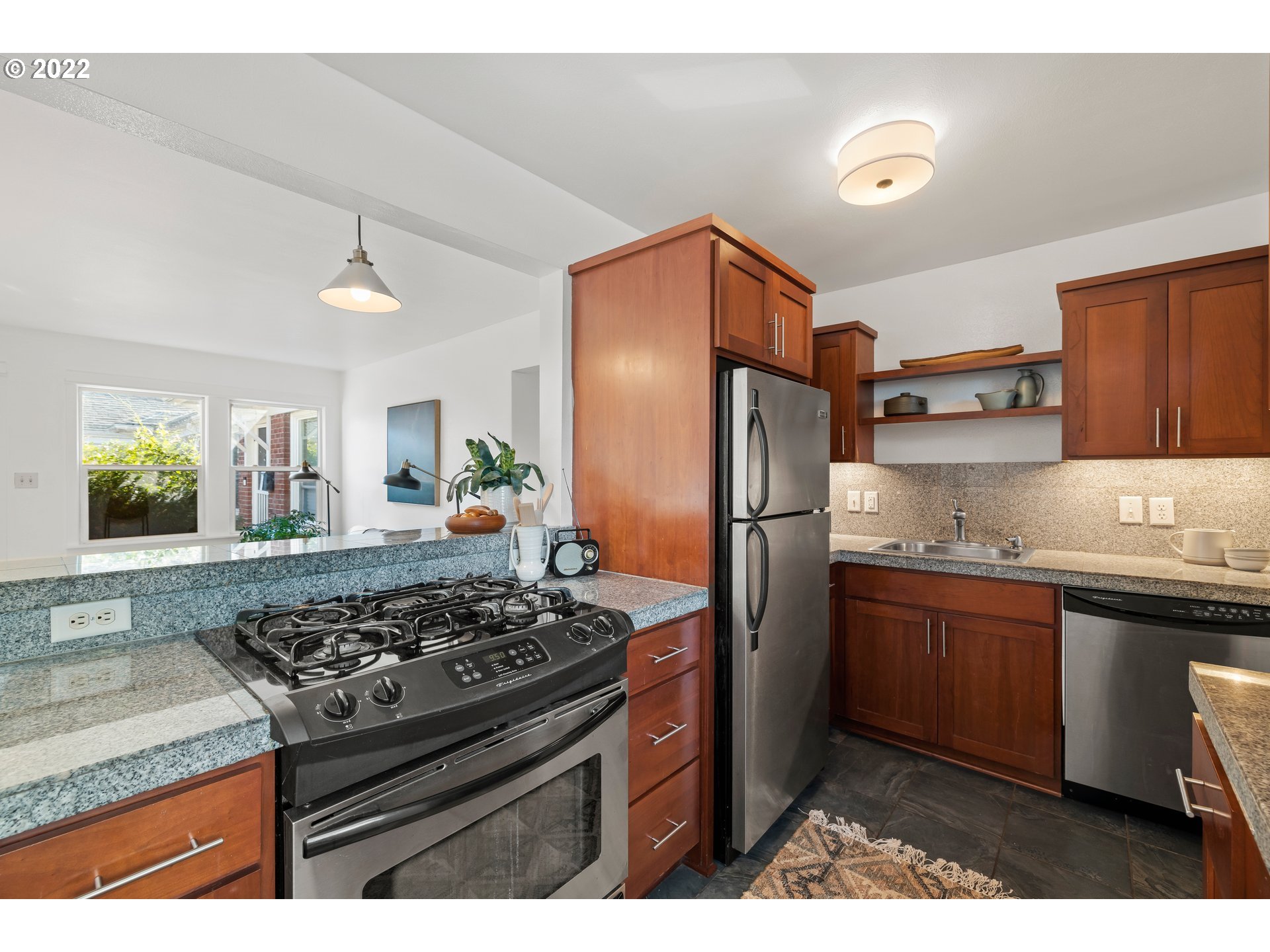 506 Northeast Rosa Parks Way, Unit 2 Portland, OR 97211 - Photo 6 of 17 a kitchen with stainless steel appliances granite countertop a sink stove and refrigerator